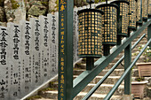 Prayer Wheels (Mani Wheels) at the Daisho-in Temple; a Japanese Buddhist temple affiliated with the Shingon sect, situated at the base of Mount Misen, Miyajima Island, Hiroshima Prefecture, Japan.