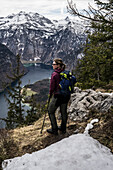  Hiker high above Lake Königssee, Berchtesgaden Alps, Bavaria, Germany 