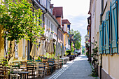  Glockenstraße with historic Huguenot houses and street cafe in the early morning in Erlangen, Middle Franconia, Franconia, Bavaria, Germany 