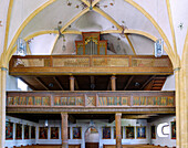  Organ loft with wood carvings and Stations of the Cross in the interior of the late Gothic parish church of St. Stephen in Haiming, Upper Bavaria, Bavaria, Germany 