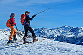  Two people on ski tour enjoying the view, Rosskopf, Hochfügen, Tux Alps, Tyrol, Austria 