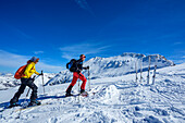 Two people on ski tour ascending to the Kleiner Pleißlingkeil, with the Großer Pleißlingkeil in the background, Kleiner Pleißlingkeil, Niedere Tauern, Salzburg, Austria 