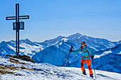  Woman on ski tour ascending to Baumgartgeier, Großvenediger in the background, Baumgartgeier, Tyrol, Austria 