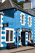 Two men sitting outside the blue Hook'd Fish & Chips shop, Tobermory, Isle of Mull, Argyll and Bute Council, Scotland, United Kingdom, Europe