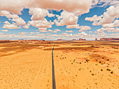 Long straight road through the Monument Valley, Arizona, USA