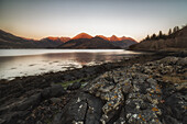 Blick über den See Loch Duich auf die Bergkette der five Sisters zum Sonnenuntergang, Schottland, Großbritannien