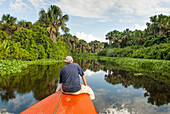 Man sitting on prow of a dugout canoe on Tigre river, tributary of Orinoco river,Monegas State, Bolivarian Republic of Venezuela, South America