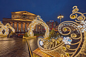 Brightly illuminated festive Christmas decorations in front of Bolshoi Theater in the historic center of Moscow, Russia.