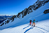  Two people on ski tour ascending to the Äußerer Falk, Zillertal Alps, Tyrol, Austria 