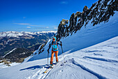  Woman on ski tour ascending to the Äußerer Falk, Zillertal Alps, Tyrol, Austria 