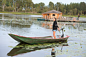 Agnes bringing , in electric boat, the dinner to a Floating cabin of Clos de la Loutre (Otter's cottage), Etang de Bornacq, Loye-sur-Arnon, Cher department, Historic Province of Berry, Centre-Valde Loire region,