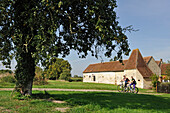 Young women cycling around Corbon,Regional Natural Park of Perche,Orne department,Lower Normandy region,France,Western Europe