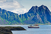  Typical mountain landscape with a fishing boat, Svolvaer, Lofoten, Nordland, Norway 