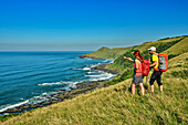  Two people hiking looking at the Indian Ocean coast, Wild Coast Trail, Wild Coast, Eastern Cape, South Africa 
