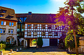 City Square with House and Tree in a Medieval Old Town in a Sunny Summer Day with Tunnel with Blue Sky and lens Flare in Regensberg, Zurich Canton, Switzerland.