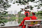 Women dressed with traditional costume, Hoen Kiem lake, Hanoi, Northern Vietnam, Southeast Asia