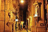 Statues of saints at the corner of West and Old Theatre Streets, with St Paul's Pro-Cathedral in the background, Valletta, Malta, Southern Europe