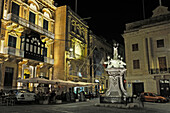 Statue of St. Lawrence in front of the BeBirgu Cafe & Brasserie in the unique setting of the historical San Lawrenz Band Club Palazzo at the Victory Square (Misrah ir-Rebha) of Birgu Vittoriosa,Three Cities, Malta, Southern Europe