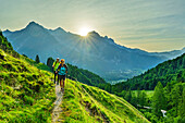  Man and woman hiking with the Loferer Steinberge mountains in the background, Lindtalalm, Kitzbüheler Horn, KAT Walk, Kitzbühel Alps, Tyrol, Austria 
