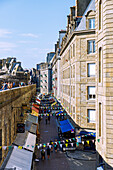 View from the city wall onto Rue Jacques Cartier with restaurants and cafés Intra Muros on the fortified island of Ville Close in Saint-Malo, Côte d'Emeraude, Côtes-d'Armor, Brittany, France