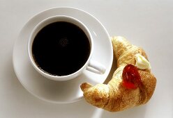 Cup of coffee; Croissant with Jam and Butter