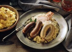 Blood and liver sausages with smoked pork on sauerkraut