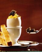 Egg shell filled with scrambled egg & caviare in egg cup