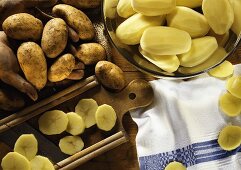 Potatoes in a hand, peeled potatoes & potato slices
