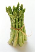 Bundle of green asparagus, standing on white background