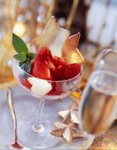Raspberry sorbet in glass with lychees & star wafers