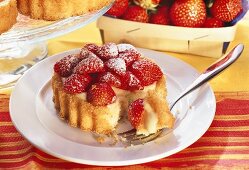 Strawberry tartlet with vanilla cream, piece on fork