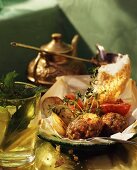 Tray-baked Turkish koftas with bread and potato wedges