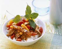Duck with pineapple, peppers and rice in bowl