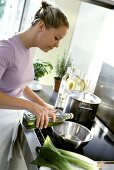 Young woman pouring oil into a metal dish