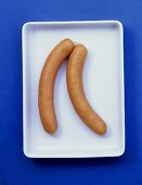 Two frankfurters in shallow bowl