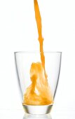 Pouring multi-vitamin juice into a glass