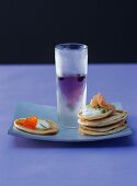 Blinis with caviare & salmon & a glass of blueberry vodka