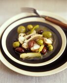 Braised rabbit with olives and spring onions