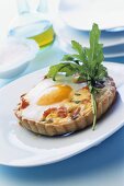 Cheese and salmon tartlet with fried egg (duck egg)