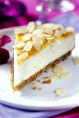 A piece of ricotta cheesecake with flaked almonds