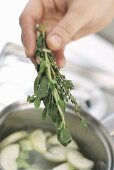 Adding herbs to soup