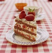 A piece of chocolate sponge cake with fresh strawberries