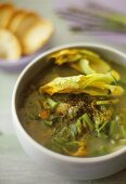 Gemüsesuppe mit grünem Wildspargel und Zucchiniblüten