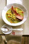 Pea soup with root vegetables, potatoes and belly pork