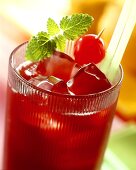 Cherry drink with fruit juice ice cubes