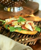 Baguette with ham, artichokes and herbs