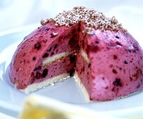 Domed berry gateau, a piece cut