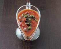 Tomato, anchovy and caper sauce in sauce-boat