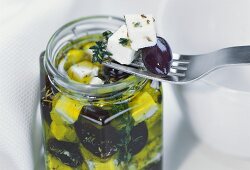 Sheep's cheese with olives in olive oil