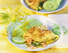 Herb omelette with salmon and cucumber slices